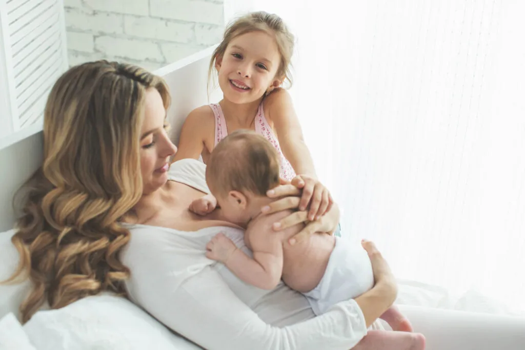Mãe sorrindo com seus dois filhos ao lado dela Mãe sorrindo com seus dois filhos ao lado dela